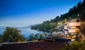 a parking lot with a view of the water at Boutique & Design Hotel Navis - Small Luxury Hotels of the World in Opatija