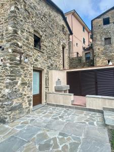 a stone building with a door and a stone patio at Casa Dell'Angelo Cherubino Monolocale in Castelnuovo Magra