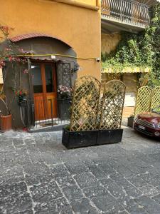 a gate in front of a building with a door at Petite Suite in Naples