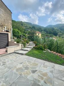 a stone patio with steps leading up to a house at Casa Dell'Angelo Cherubino Monolocale in Castelnuovo Magra