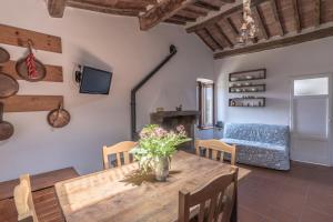a living room with a table and a couch at Antica Porta di Sovana in Pitigliano