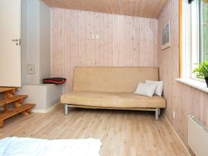 a living room with a couch and a window at 6 person holiday home in Alling bro in Nørager