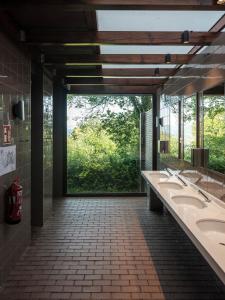 a bathroom with two sinks and a large window at Wecamp San Sebastián in San Sebastián