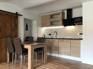 a kitchen with a wooden table and chairs at Apartmany A&Z in Hořice na Šumavě