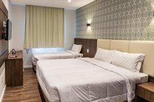 Cama ou camas em um quarto em Colina Lagos Hotel