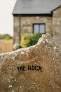 a rock with the rock written on it in front of a house at Creevy Cottages in Rossnowlagh