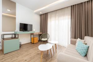 a living room with a couch and a tv at Hotel Olea in Ulcinj