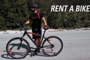 a man standing next to a bike in the street at Apartment Felix 2 in Ston