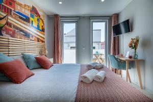 ein Schlafzimmer mit einem großen Bett mit Handtüchern darauf in der Unterkunft Casita São Gonçalinho by Home Sweet Home Aveiro in Aveiro