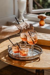 een persoon met drie glazen op een tafel bij Hotel Slottsvillan in Huskvarna
