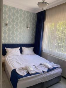 a bedroom with a bed with towels on it at My Home Sultanahmet Hotel in Istanbul