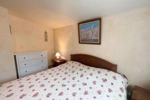 1 dormitorio con 1 cama y una foto en la pared en Binic maison de campagne, en Plourhan