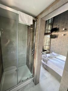 a bathroom with a glass shower and a bed at Hausboot - Domy na wodzie - Houseboat Porta Mare - Odradream in Szczecin
