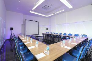 a conference room with a long table and blue chairs at Moritz Biz Gandaria in Jakarta