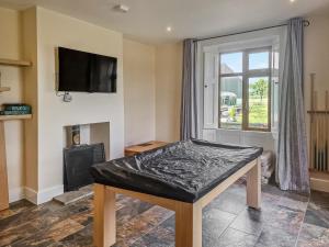 a room with a table and a window at The Farmhouse - Uk10655 in West Pennard