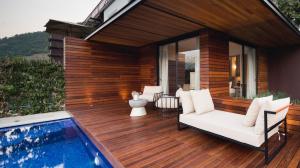 a house with a wooden deck next to a swimming pool at Quinta de S.Bernardo - Winery & Farmhouse in Mesão Frio