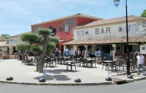 a group of people standing in front of a bar at Secret Garden - Chez Gilles et Tra - Maison d hôte -T2 super mignon, neuf et indépendant , dans cadre agréable et zen in Valergues