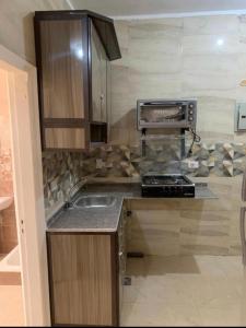 a kitchen with a sink and a counter top at استوديو للعائلات داخل قرية Retal View north coast in El Alamein