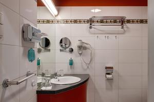 a bathroom with a sink and a mirror at Hotel Praga 1885 in Prague