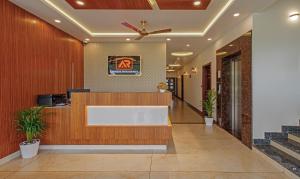 an office lobby with a reception desk and stairs at Treebo Trend Amigos Residency in Cochin