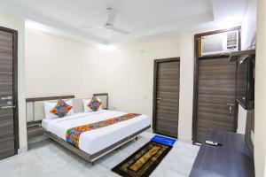a bedroom with a bed and two sliding doors at FabExpress Royal Orbit in New Delhi