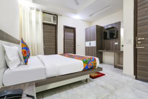 a bedroom with a bed and a television in it at FabExpress Royal Orbit in New Delhi
