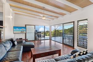 a living room with a couch and a table at 19a George Nothling Drive in Point Lookout