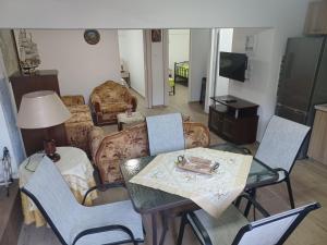 a living room with a table and chairs at Villa Filimon in Nea Vrasna