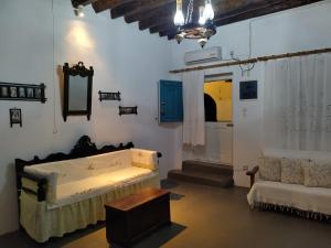 a room with a bed and a couch and a chair at Φως (Fos) in Astypalaia