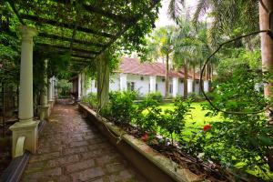 a garden with a pathway and a house at Softouch Ayurveda Village Kerala in Kizhake Chālakudi