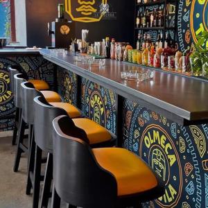a bar with a row of stools in a restaurant at Boho Boutique Hotel Amman in Amman