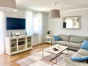 a living room with a couch and a flat screen tv at Villa Marta in Opatija