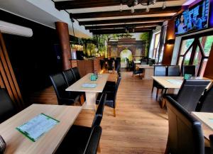a dining room with wooden tables and chairs at Noclegi Między Parkami in Milicz