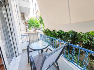 d'un balcon avec une table, des chaises et une fenêtre. dans l'établissement SAV12 Family Apartment Patisia Athens, à Athènes