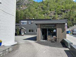 a building with the entrance to a garage at Den Vesle Sjarmøren As The most central place in Årdal ! Free Parking on the site ! in Årdal