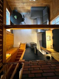an inside view of a cabin with a kitchen and stairs at Black Work Levi Autti in Kittilä
