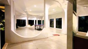 a large room with a table in the middle at Freja House @ Central BSD in Samporo