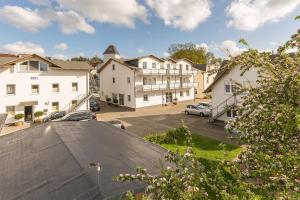 a view of a town with cars parked in a parking lot at Pension Anker in Binz