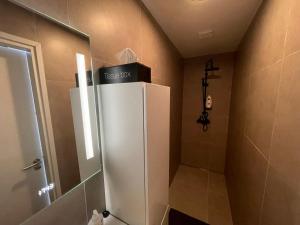 a white refrigerator in a bathroom with a shower at Residentie de Eikhof in Hengelo