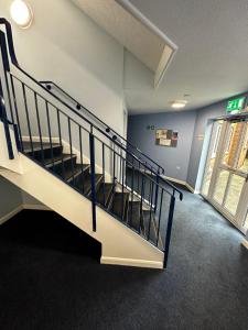 a staircase in a building with a stair case at 2 Bedroom Apartment - 11 Parry Court in Nottingham