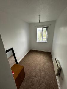 an empty room with a window and a table at 2 Bedroom Apartment - 11 Parry Court in Nottingham