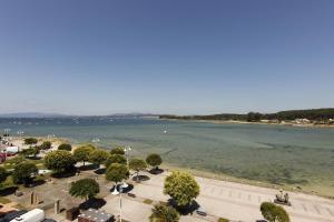 a view of a body of water with trees at El Capricho de la ría II in O Grove