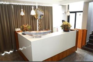 a bathroom with a large bowl sink on a counter at Luxe Inn in Kannur