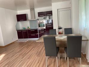 a kitchen with a wooden table and chairs in a room at Appartamento Tencia in Prato