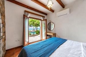 a bedroom with a bed and a view of the ocean at Leyla Luxury Villa in Pláka