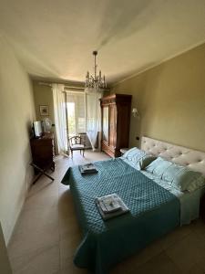 a bedroom with a large bed with a blue blanket at Bellaveduta Holidays Home in Baldissero Torinese