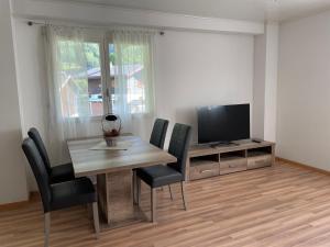 a dining room with a table and a television at Appartamento Tencia in Prato