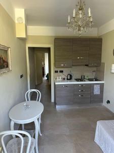 a kitchen with a table and a chandelier at Bellaveduta Holidays Home in Baldissero Torinese