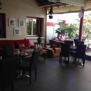 a living room with a couch and a table and chairs at Hotel Cote Patio in Nîmes