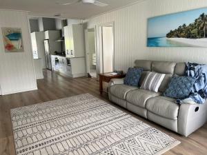 a living room with a couch and a kitchen at Seamist @ Scotts Head in Scotts Head